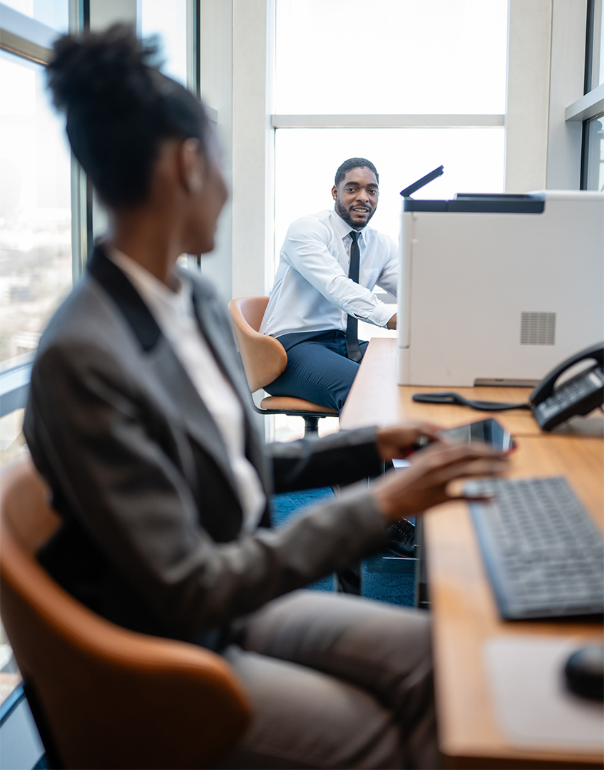 Financial professionals discussing 401(k) investment options in a modern office