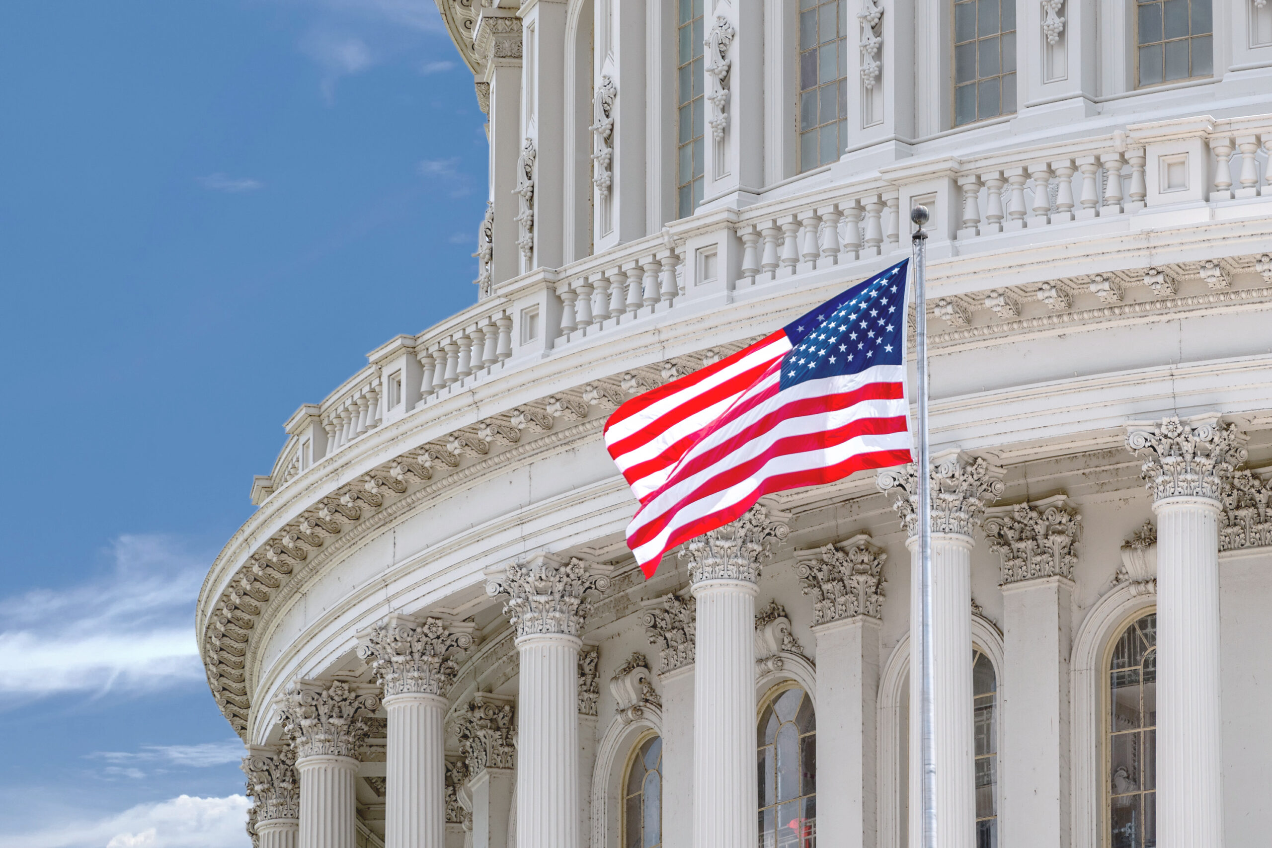 Capitol building with American flag representing retirement plan tax incentives and federal policy